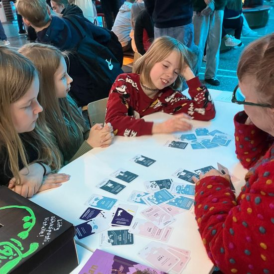 Behavioral psychologist Sinikka Hynninen-Otva leading a Climate Call game session with students during the launch of the Finnish version (Ilmastotietäjä) during the Sci Fest in Joensuu, May 2025